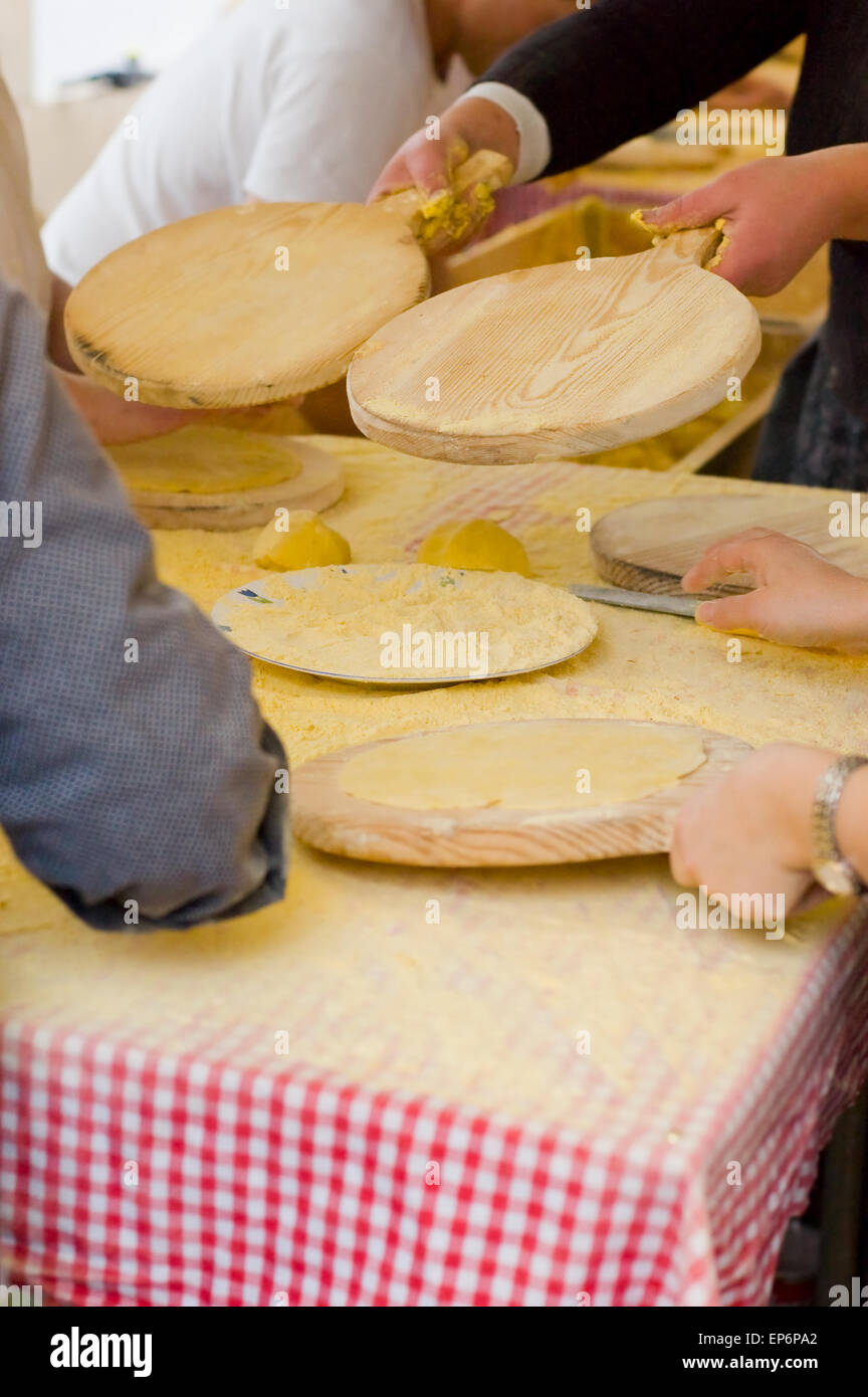 Womans making talos, Tortilla than wraps txistorra in the Santo Tomas Fair held each year on December 21st in the Basque Country Stock Photo