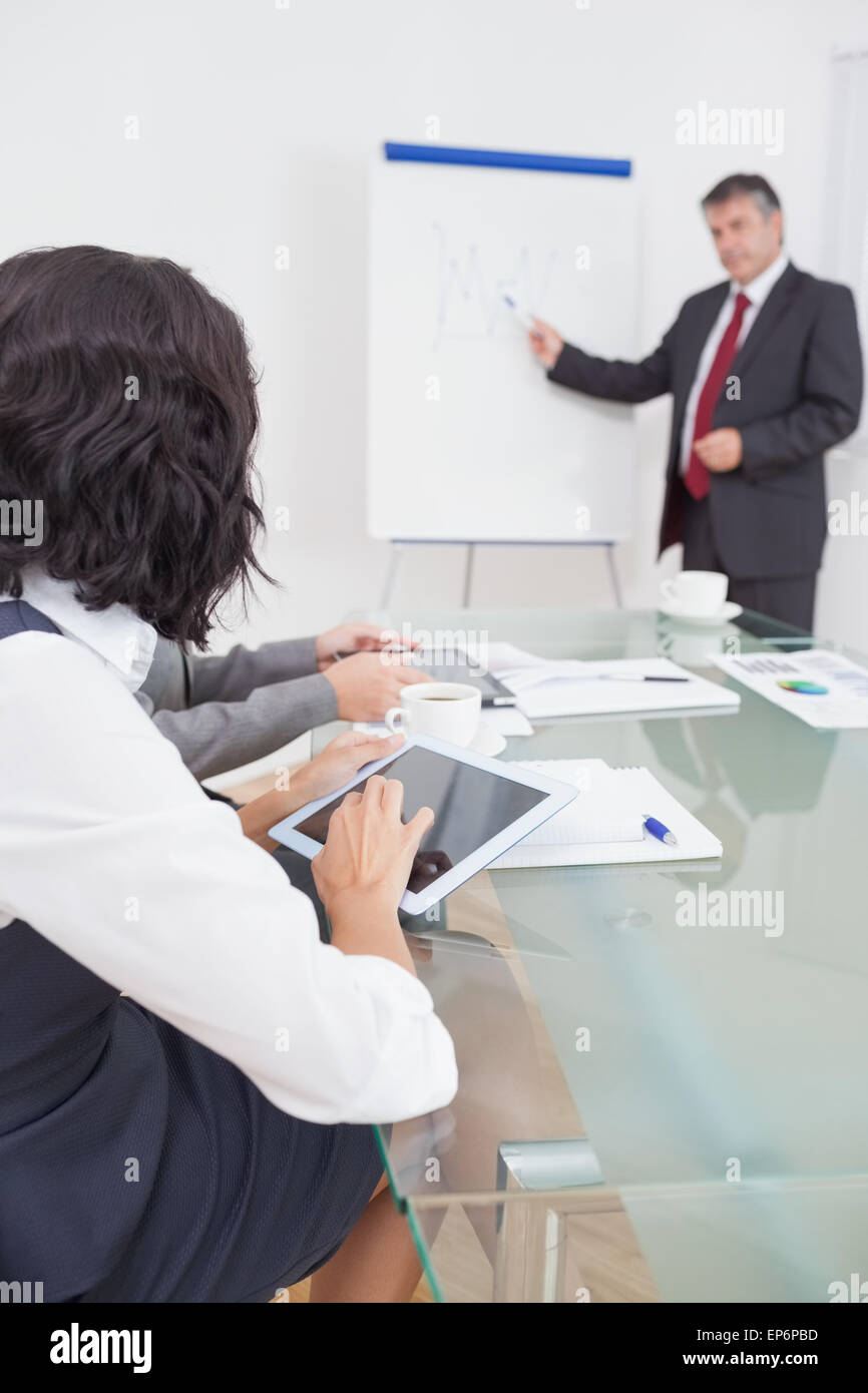 Businessman listening to a question and explaining with his marker ...