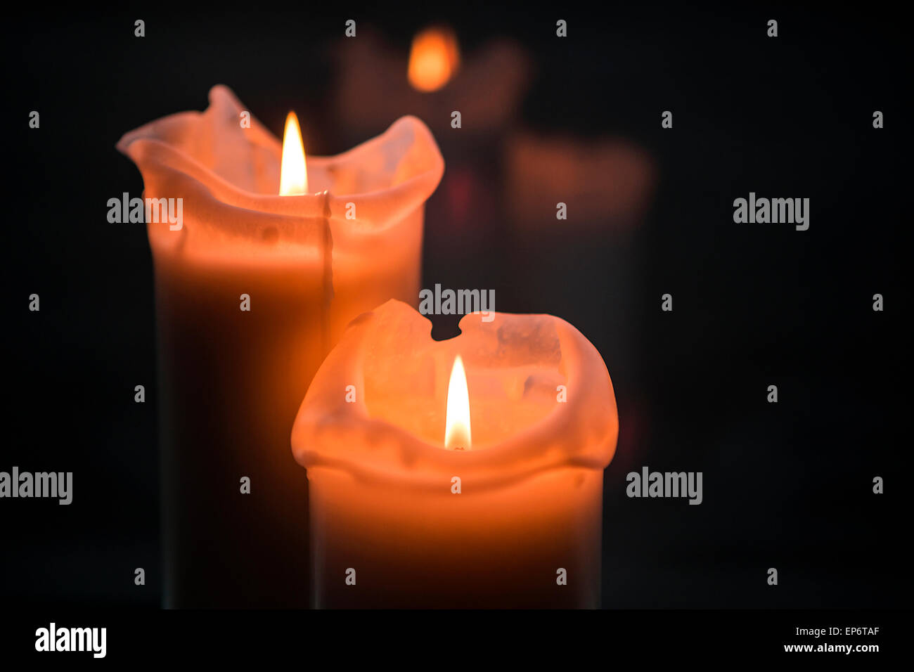 Burning candles in front of a black background Stock Photo - Alamy