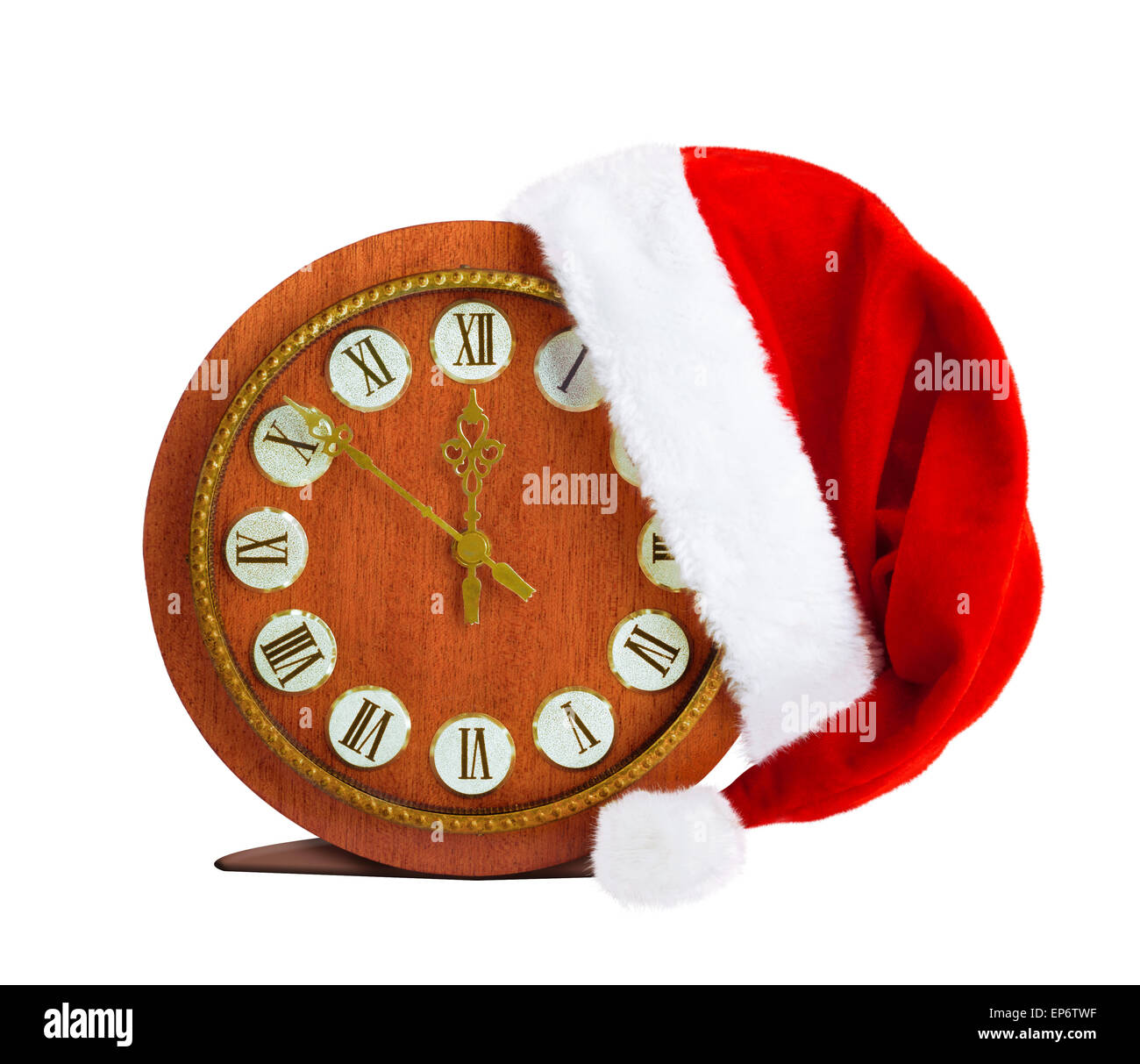 Santa Claus hat on New Year's night on the old clock showing twelve o'clock Stock Photo