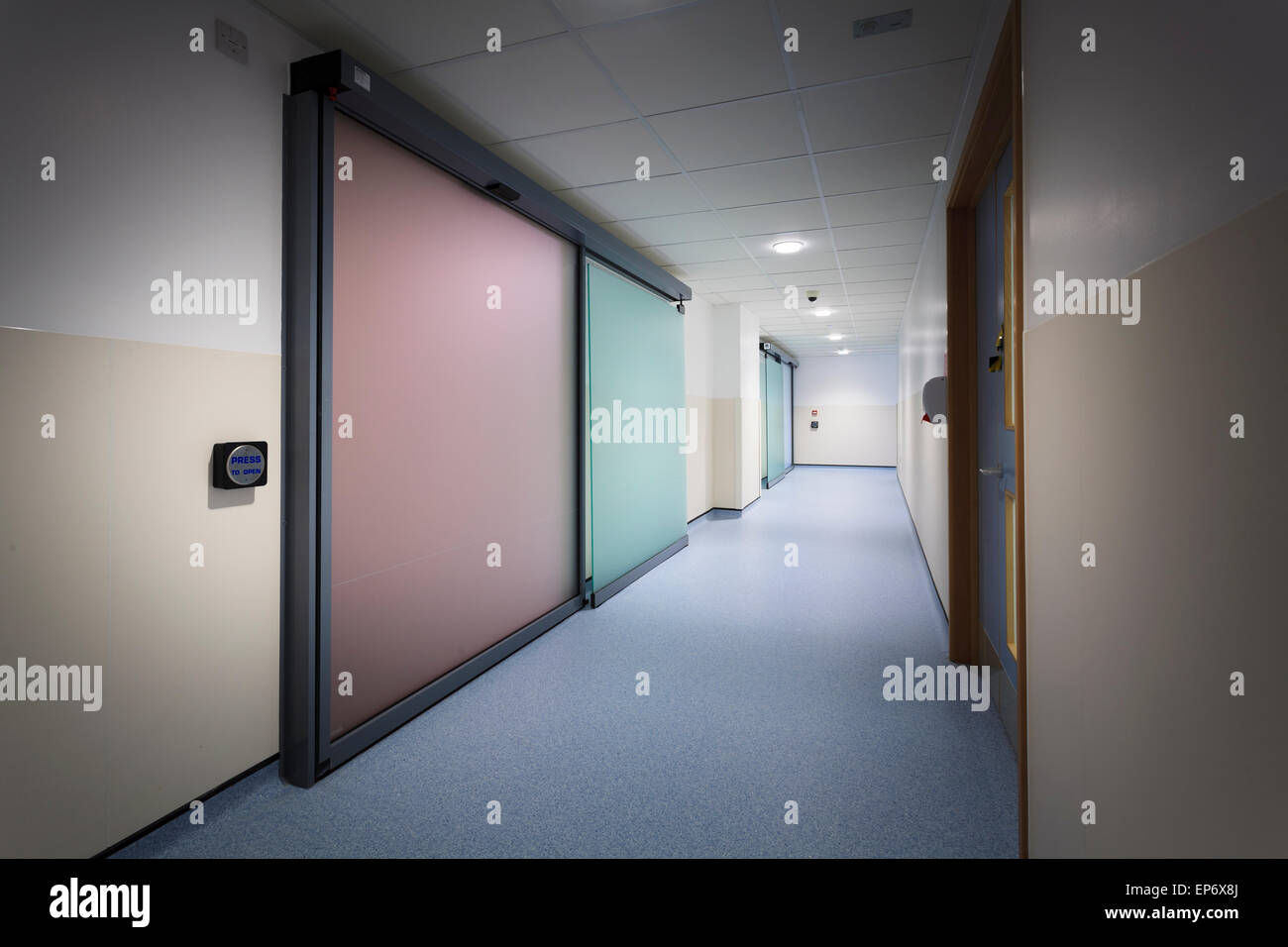 Unoccupied hospital corridor with press to open doors Stock Photo