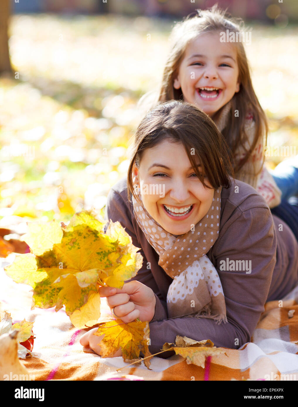 Happy young mother with daughter in autumn park Stock Photo - Alamy