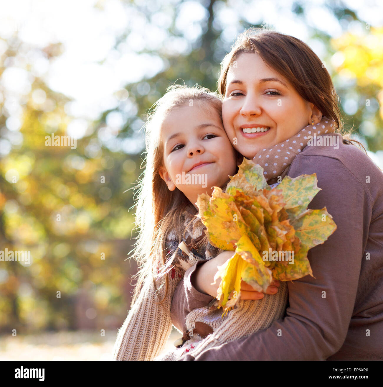 Happy young mother with daughter in autumn park Stock Photo - Alamy