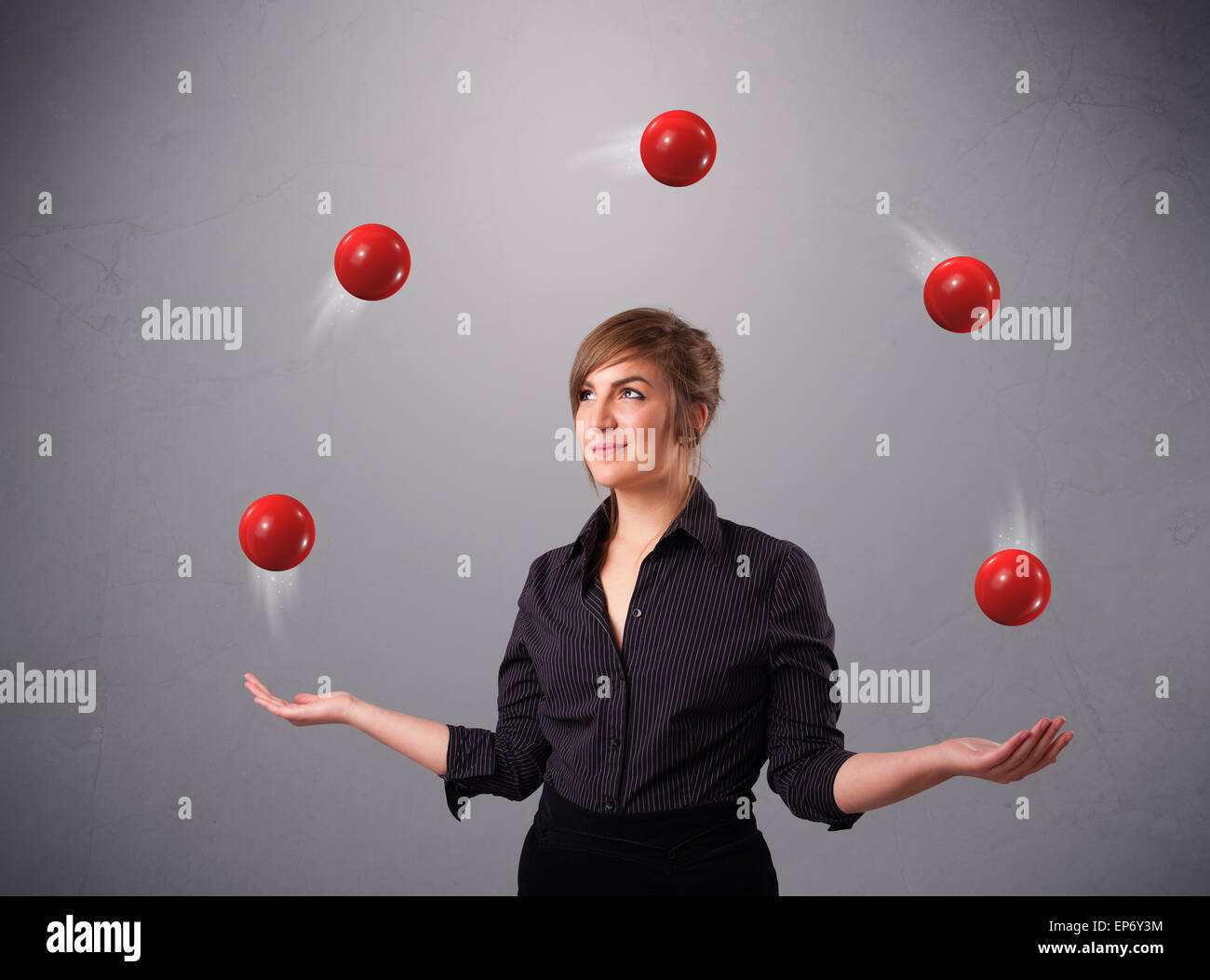 young girl standing and juggling with red balls Stock Photo Alamy
