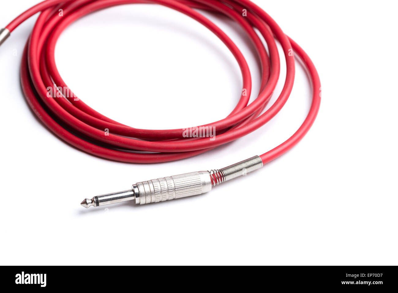 A red quarter inch cable for electric guitar isolated on a white background. Stock Photo