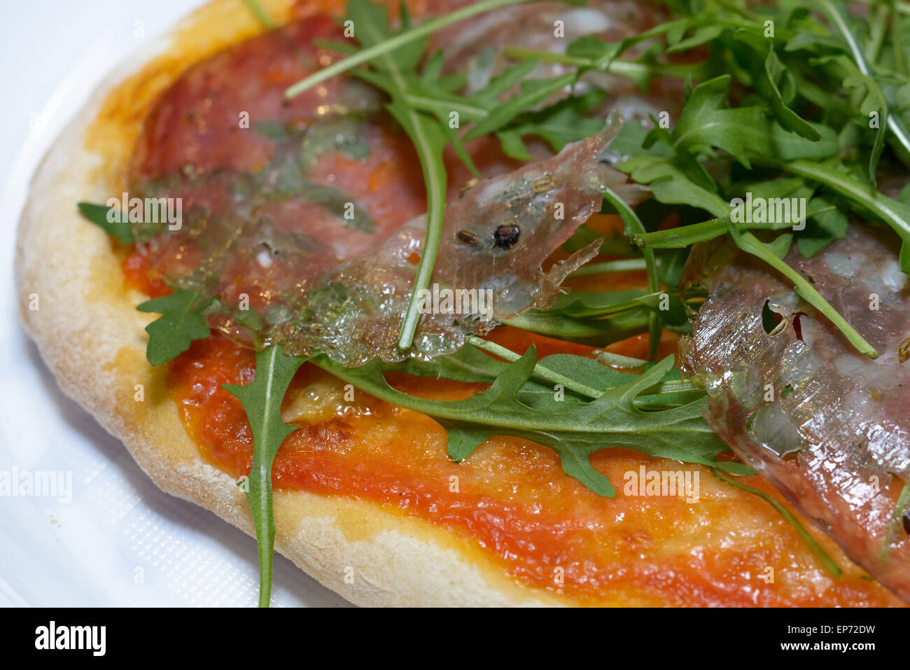 Tipical Italian Pizza with italian salami finocchiona and rucola cooked in a wood steam Stock Photo