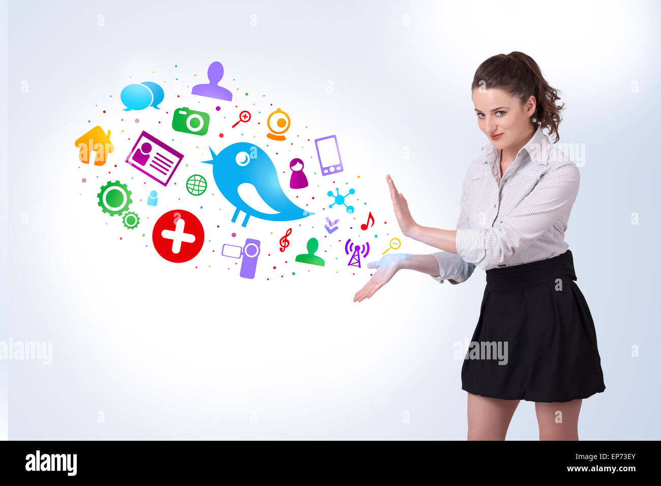Young business woman presenting colourful social icons Stock Photo - Alamy
