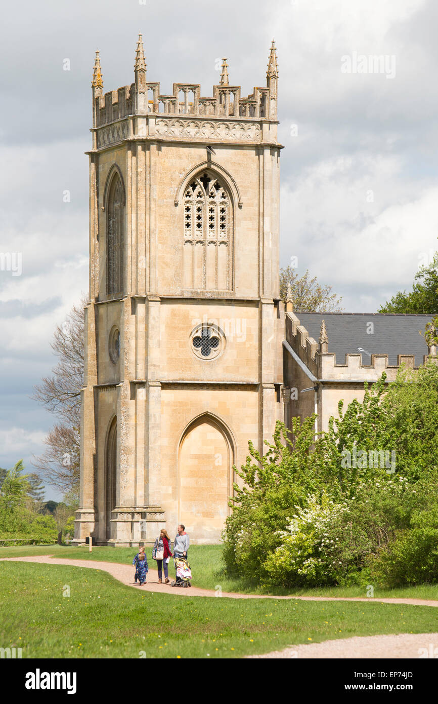 A family at Croome Court's attractive parkland and St Mary Magdalene's Church by Capability Brown, Worcestershire. England, UK Stock Photo