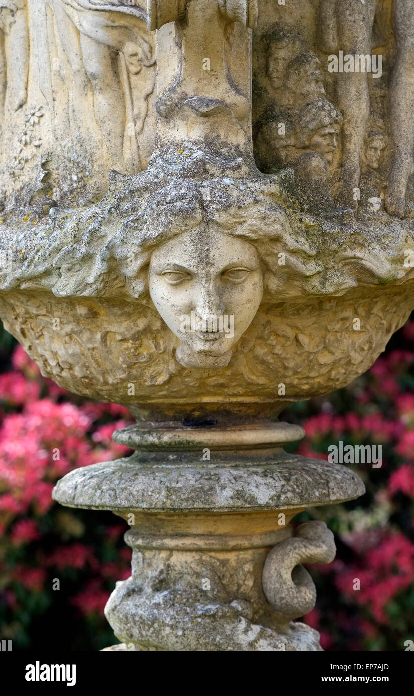 female face on decorative garden urn Stock Photo