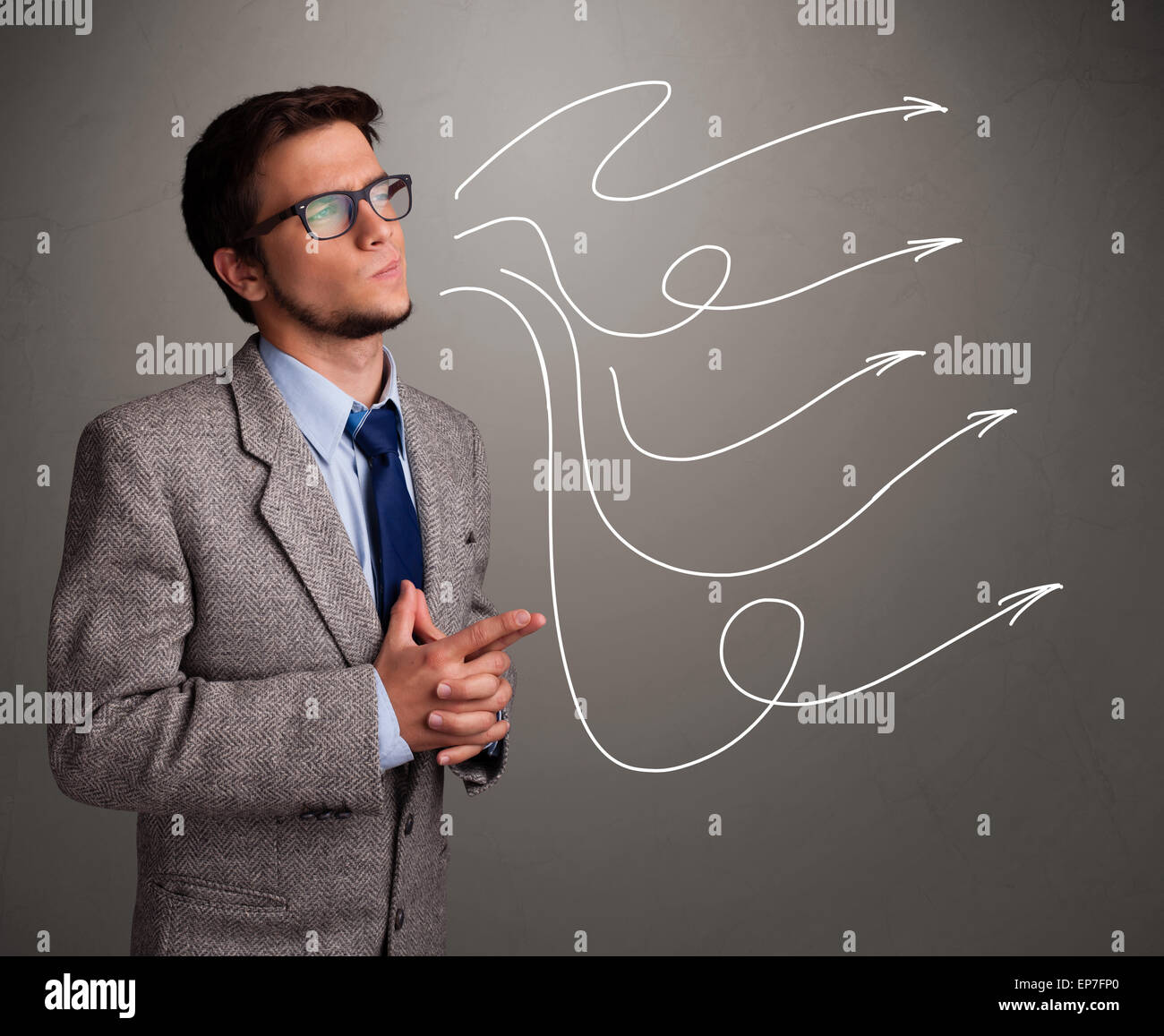 Attractive man looking at multiple curly arrows Stock Photo