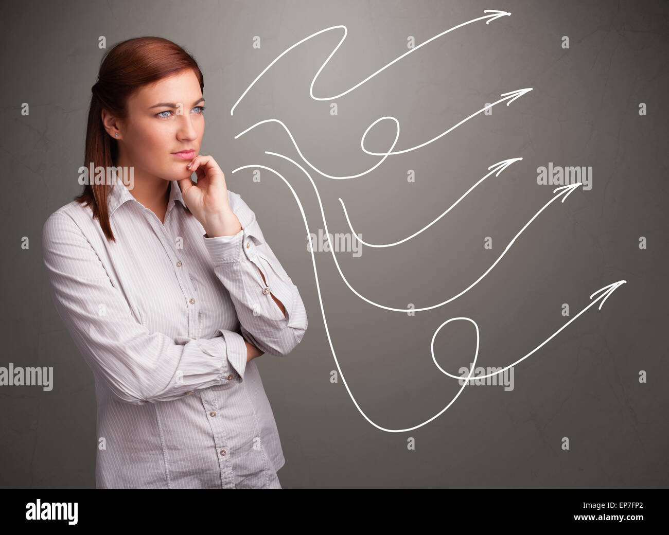Attractive teenager looking at multiple curly arrows Stock Photo