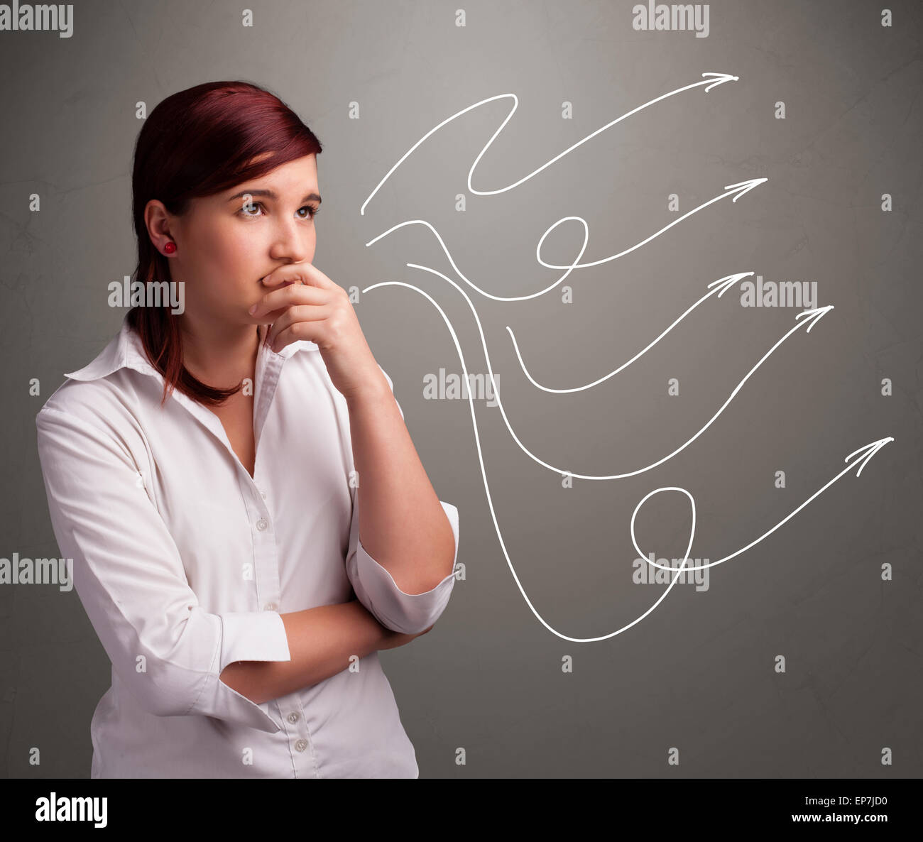 Attractive teenager looking at multiple curly arrows Stock Photo
