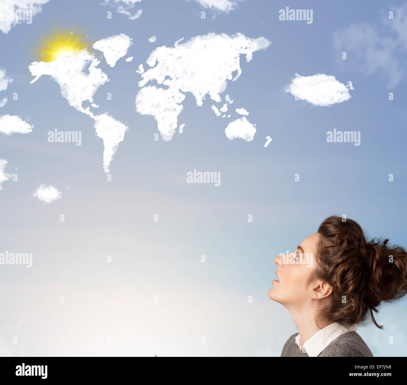 Young girl looking at world clouds and sun on blue sky Stock Photo - Alamy