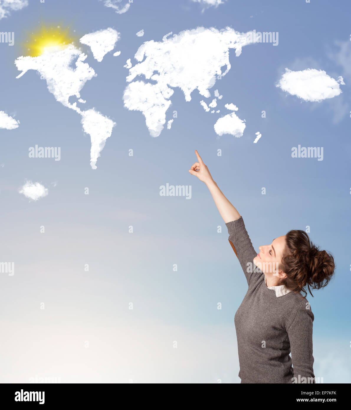 Young girl looking at world clouds and sun on blue sky Stock Photo - Alamy