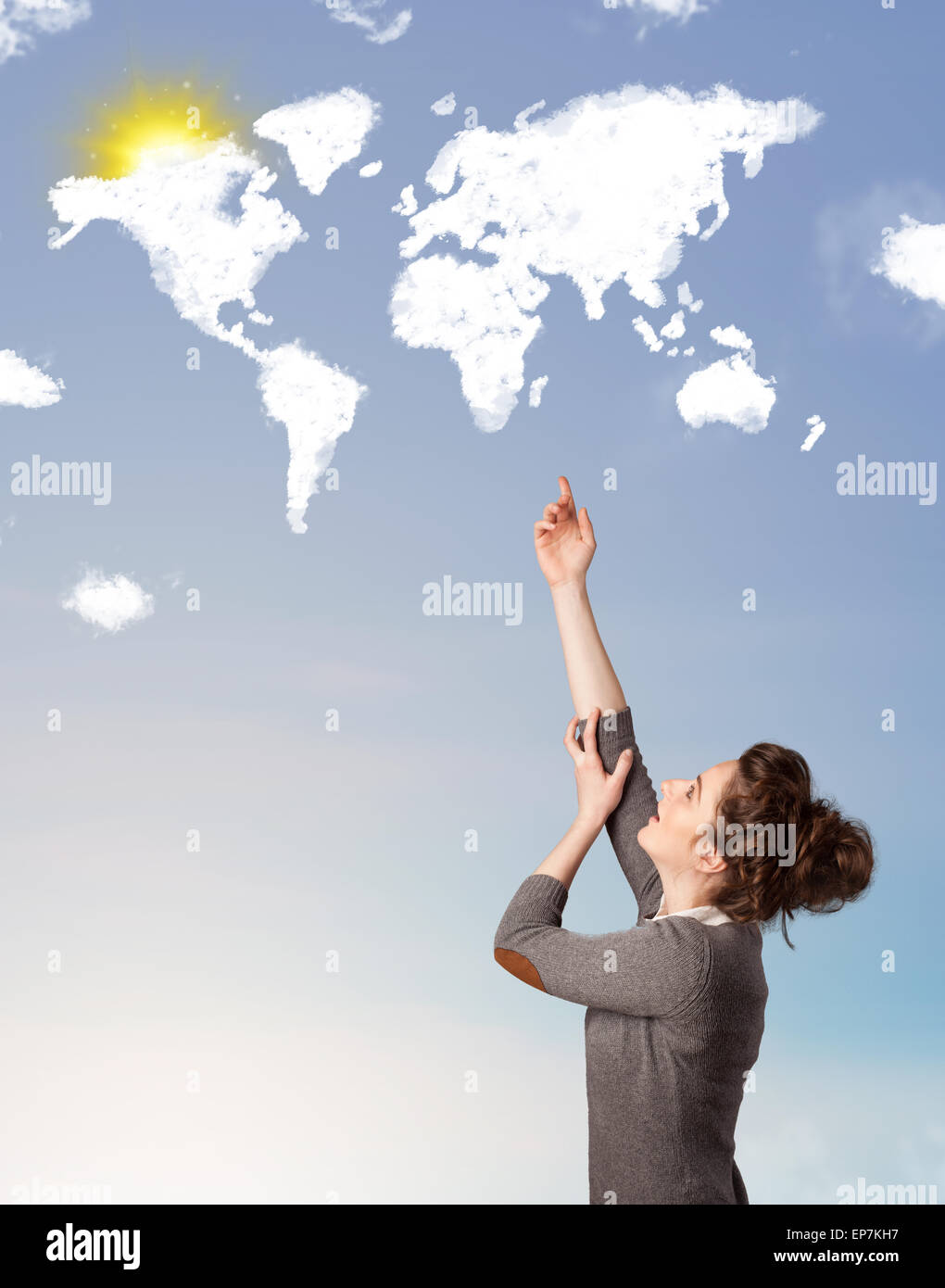 Young girl looking at world clouds and sun on blue sky Stock Photo - Alamy