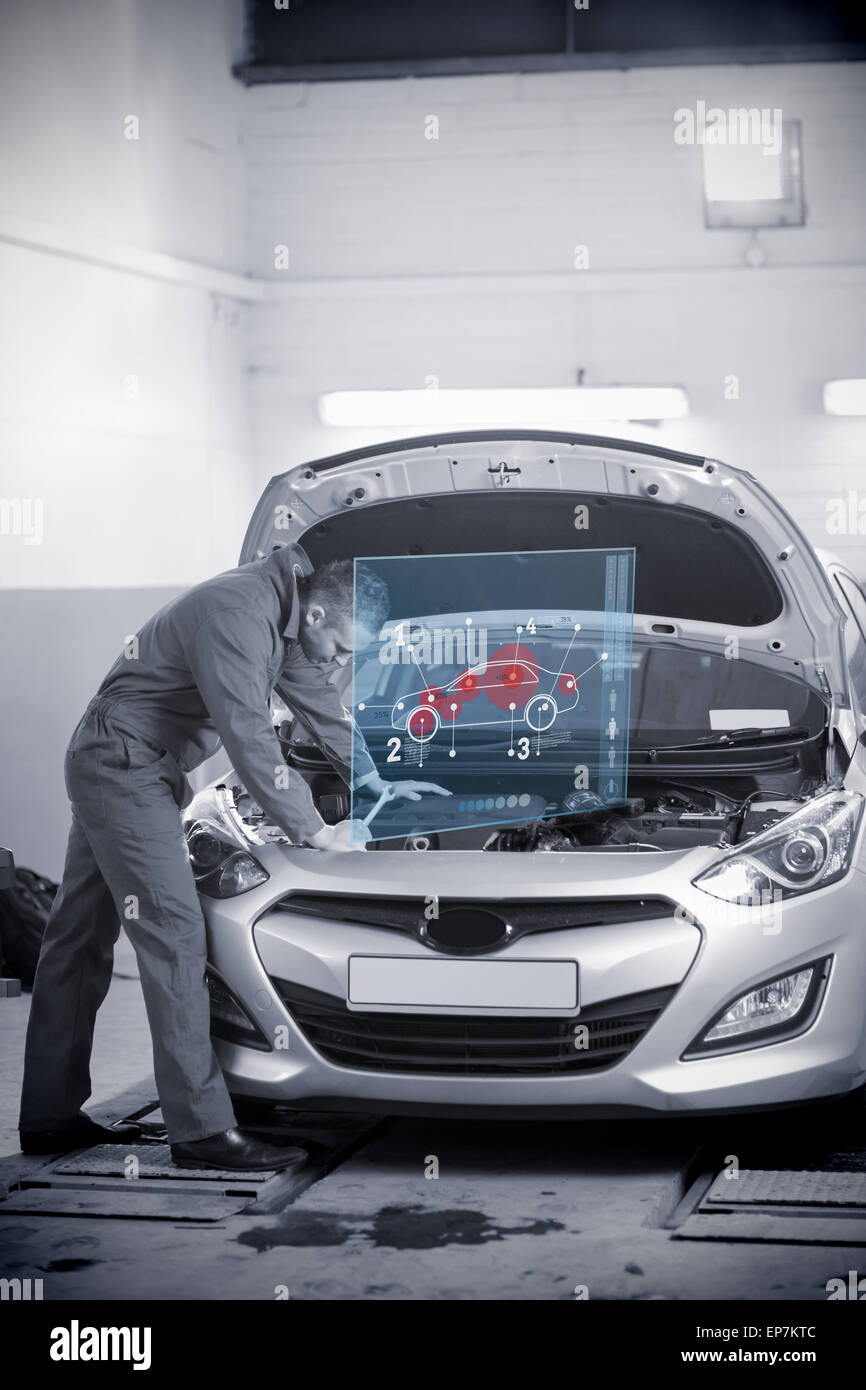 Man repairing car with open hood and futuristic interface Stock Photo