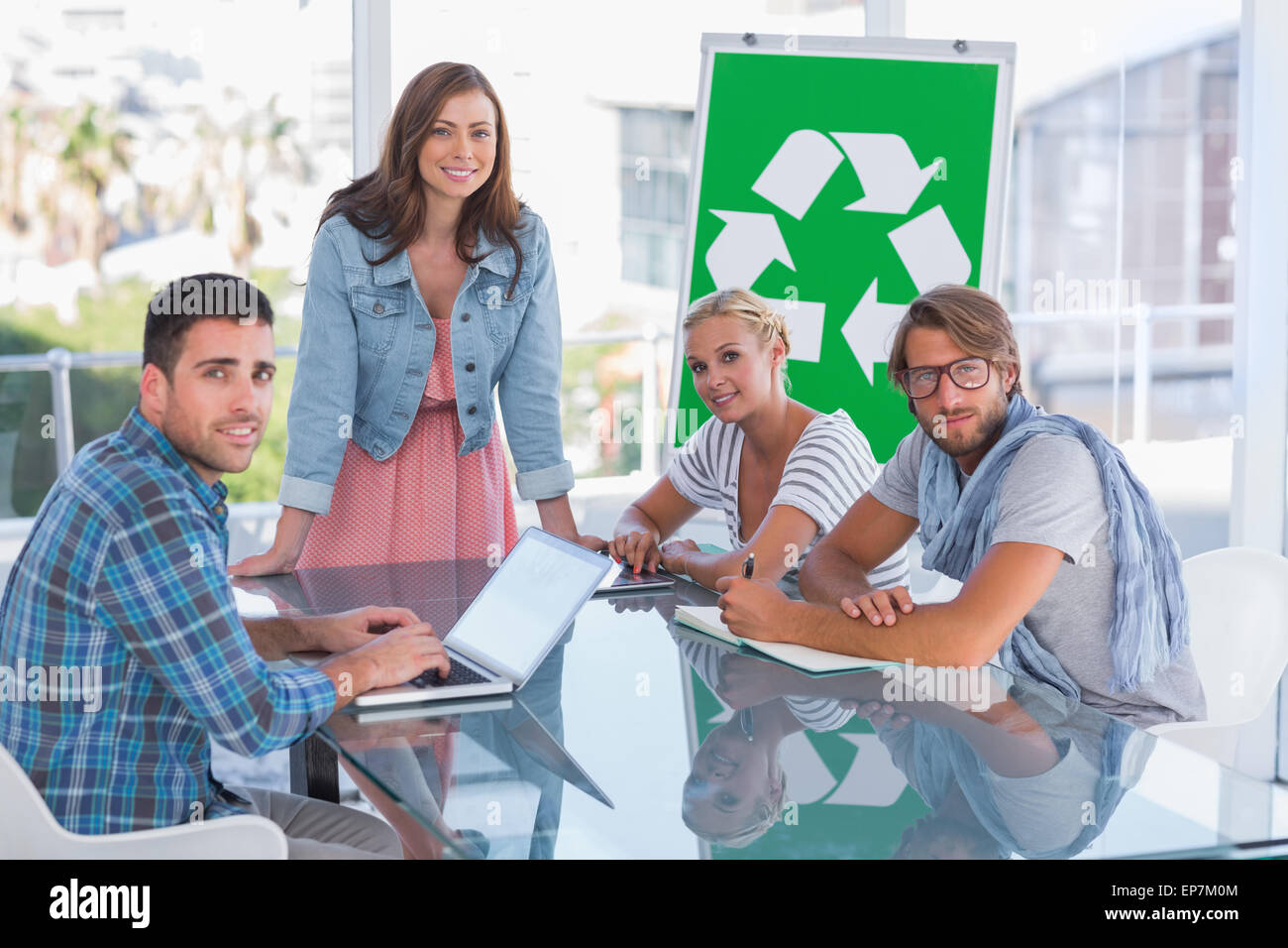Team having meeting about recycling and smiling at camera Stock Photo ...