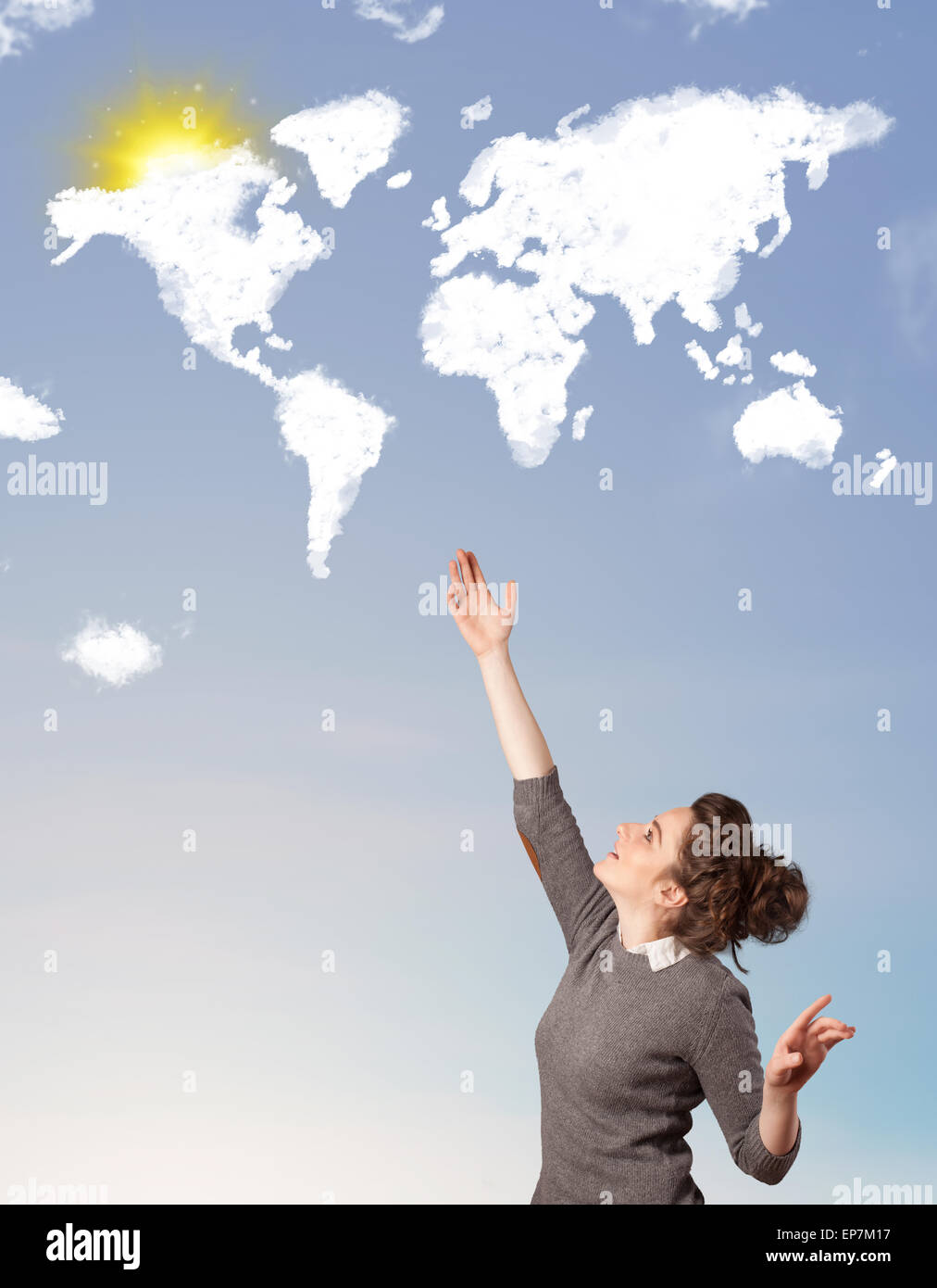 Young girl looking at world clouds and sun on blue sky Stock Photo - Alamy