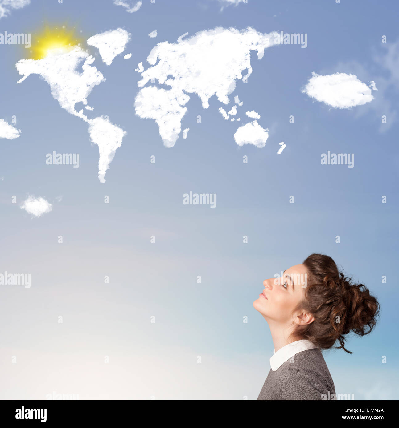 Young girl looking at world clouds and sun on blue sky Stock Photo - Alamy
