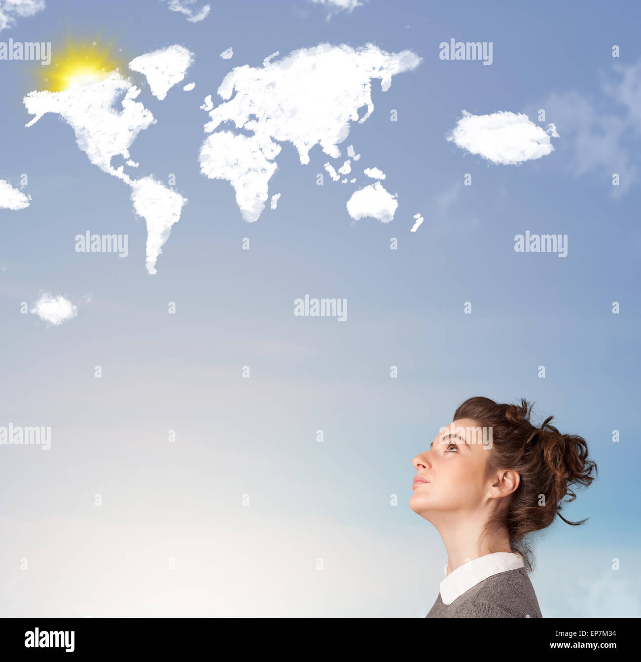 Young girl looking at world clouds and sun on blue sky Stock Photo - Alamy