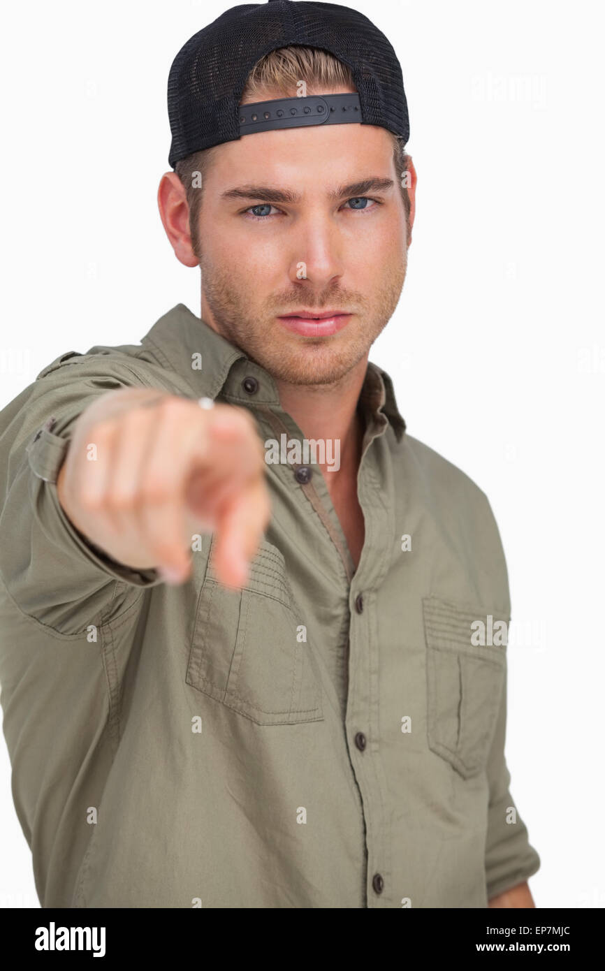 Man wearing baseball hat backwards and pointing Stock Photo