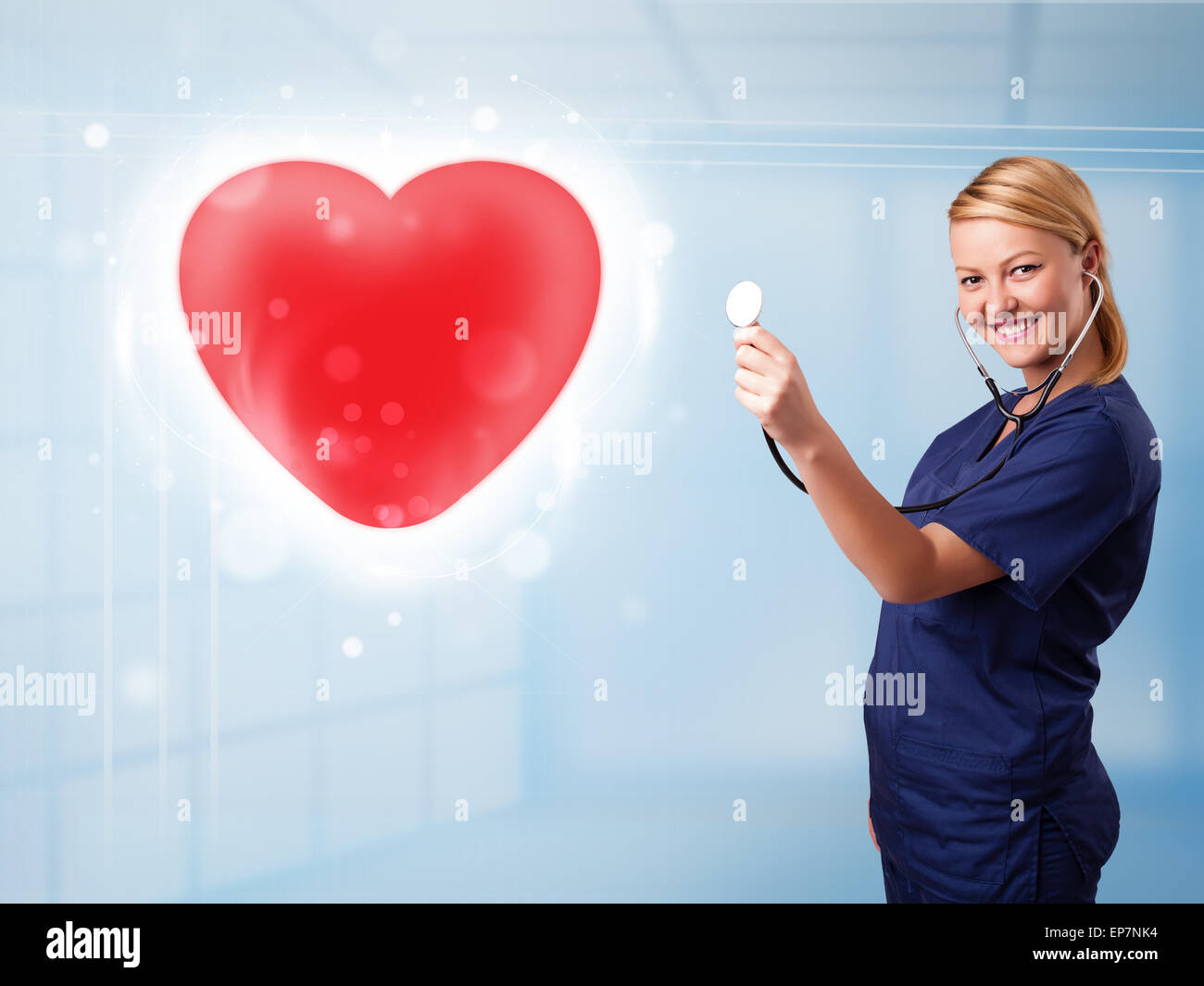 Young nurse healing a red heart Stock Photo - Alamy