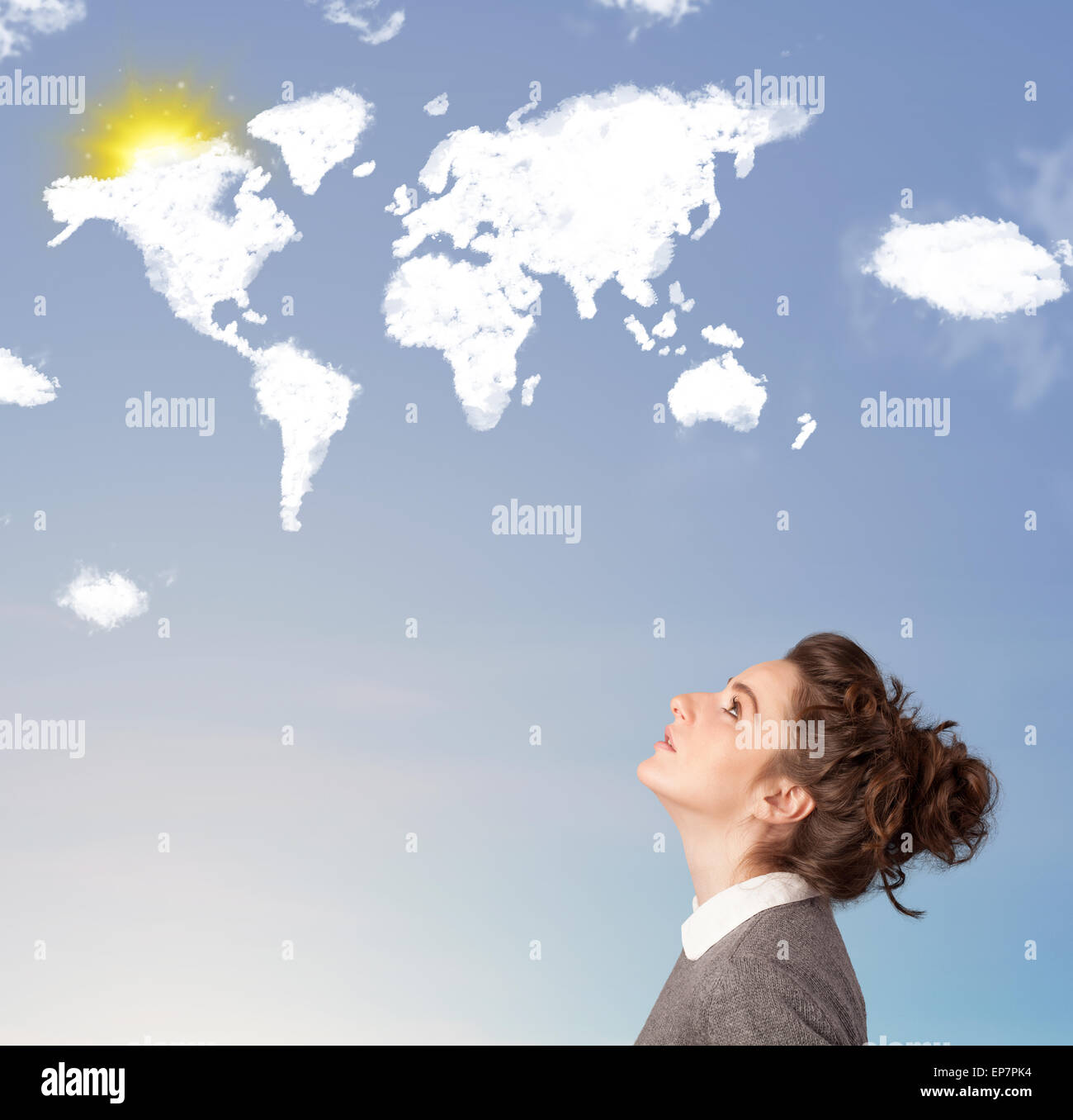 Young girl looking at world clouds and sun on blue sky Stock Photo - Alamy