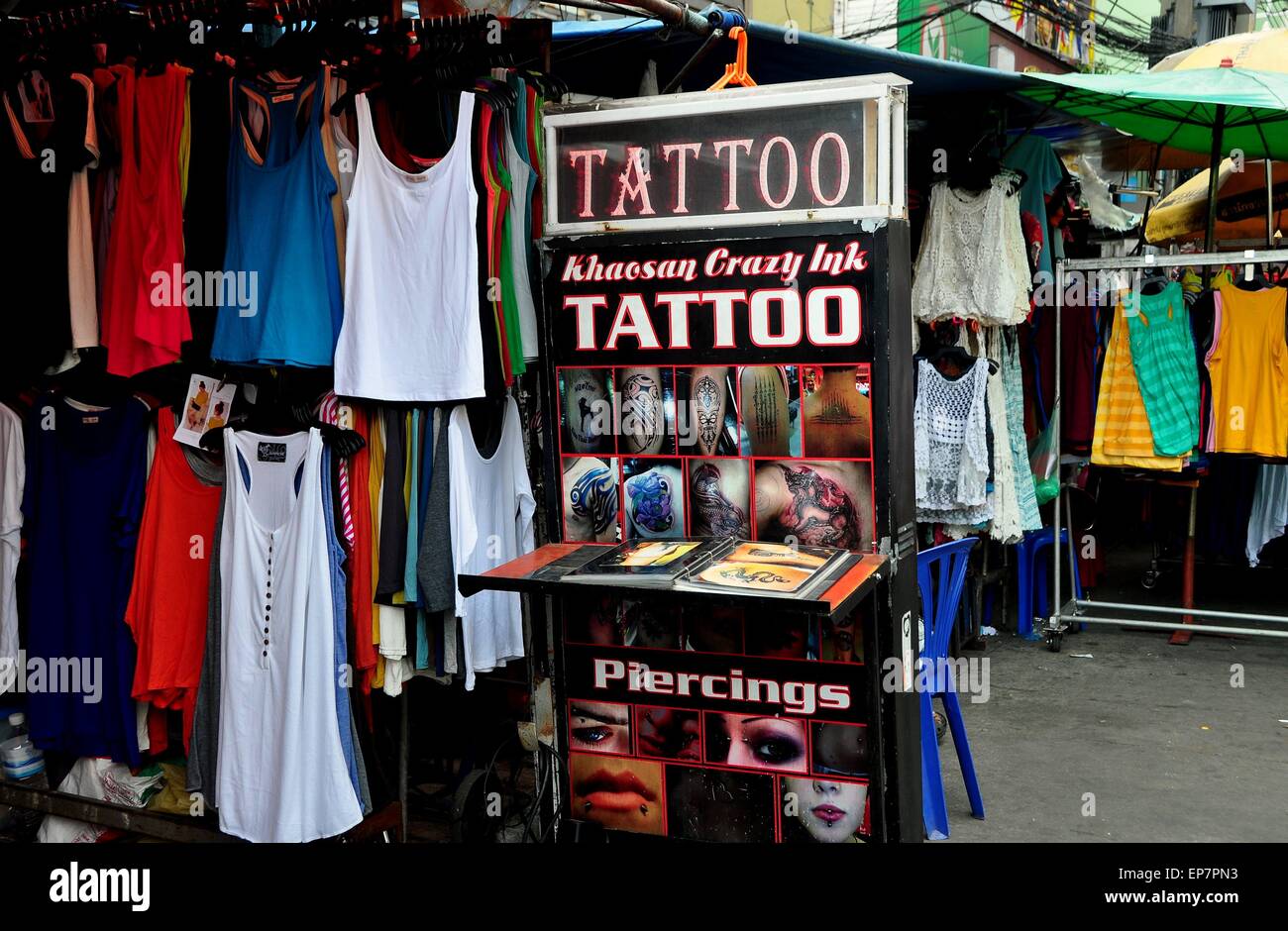 Bangkok, Thailand:  Tattoo and piercing shop's display sign at a clothing boutique on touristy Khao San Road Stock Photo