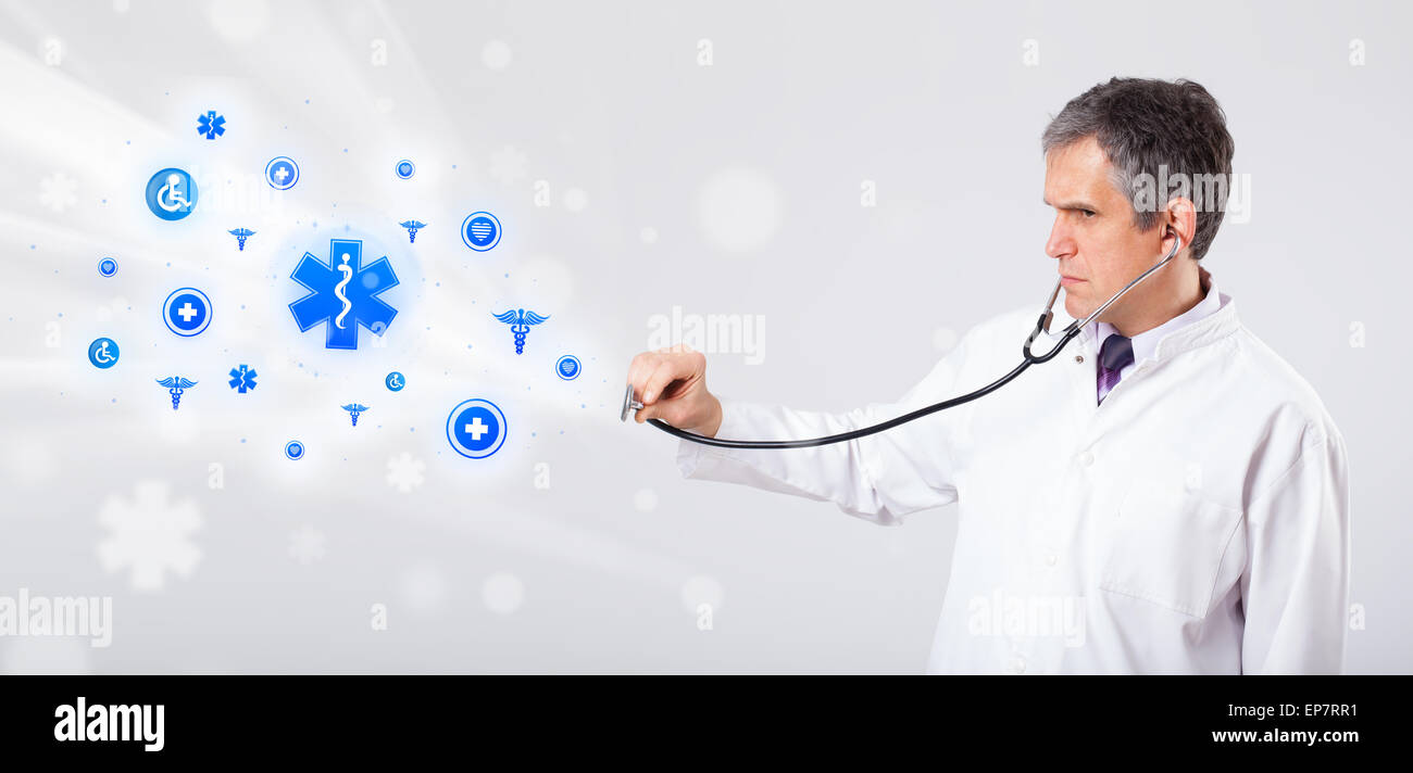 Doctor with blue medical icons Stock Photo - Alamy