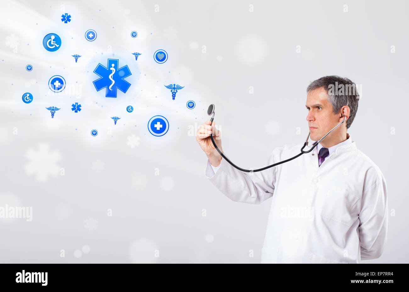 Doctor with blue medical icons Stock Photo - Alamy