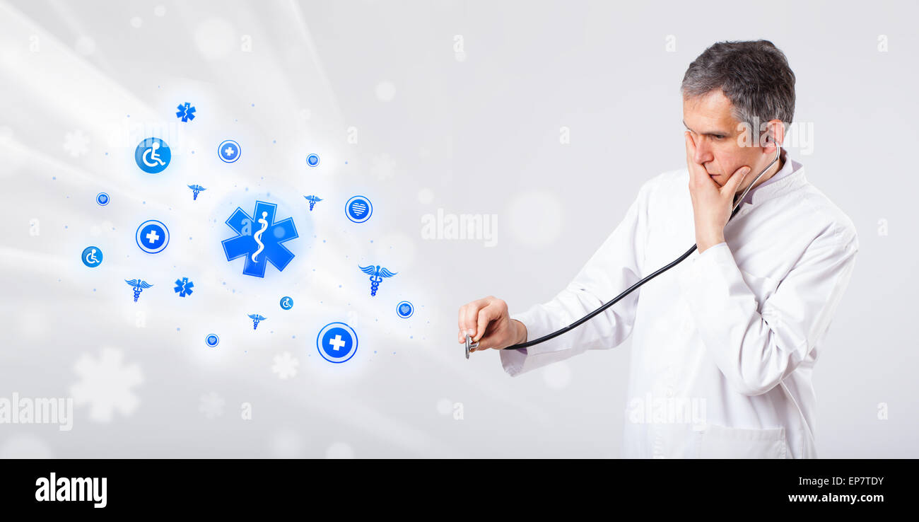 Doctor with blue medical icons Stock Photo - Alamy
