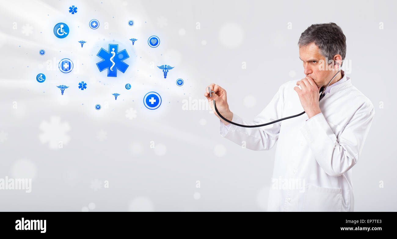 Doctor with blue medical icons Stock Photo - Alamy