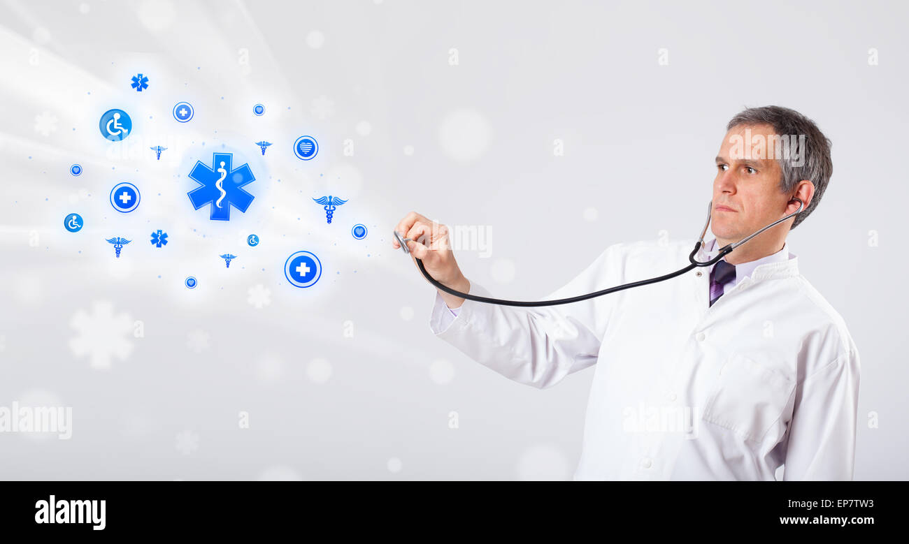 Doctor with blue medical icons Stock Photo - Alamy