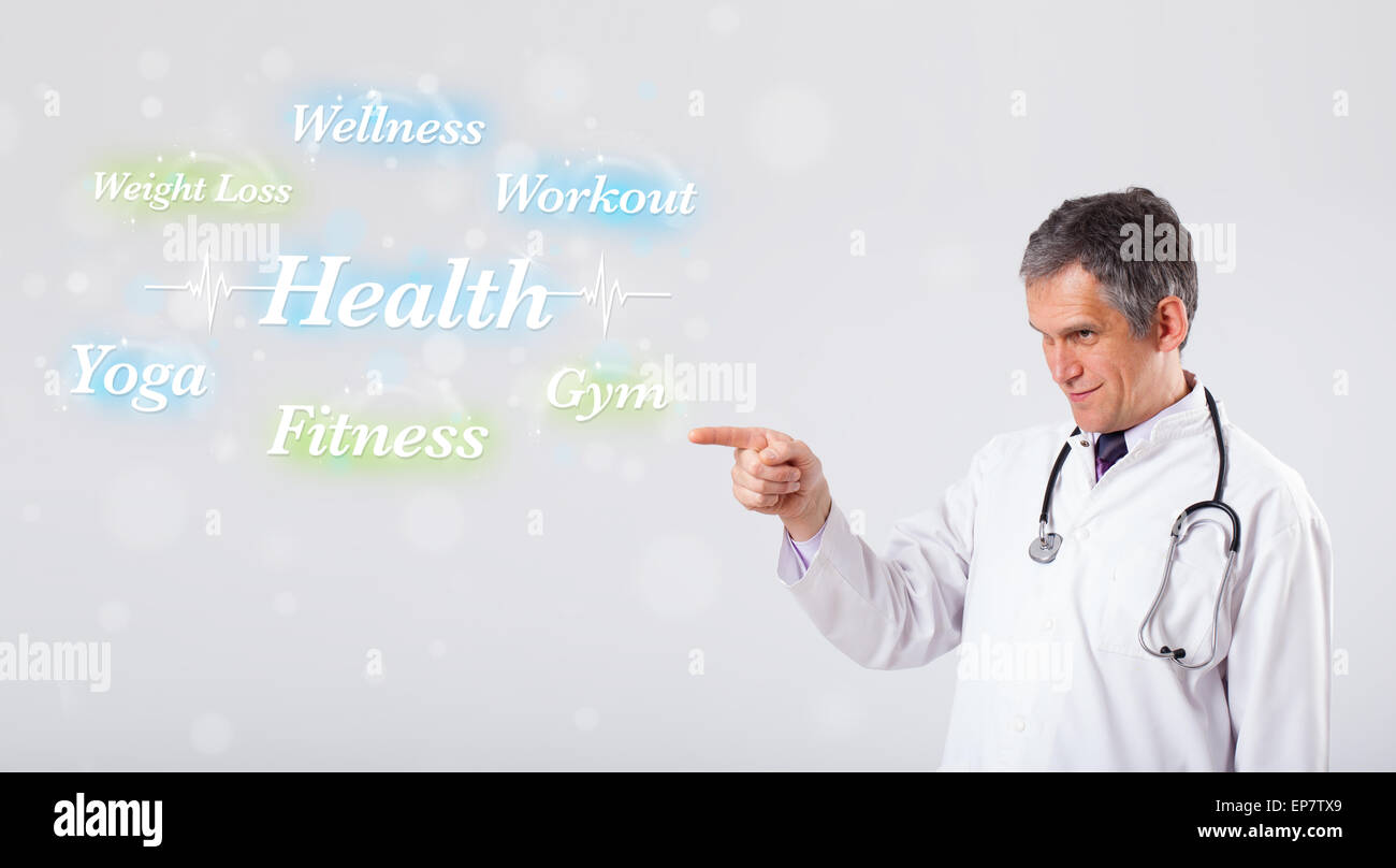 Clinical doctor pointing to health and fitness collection of words ...