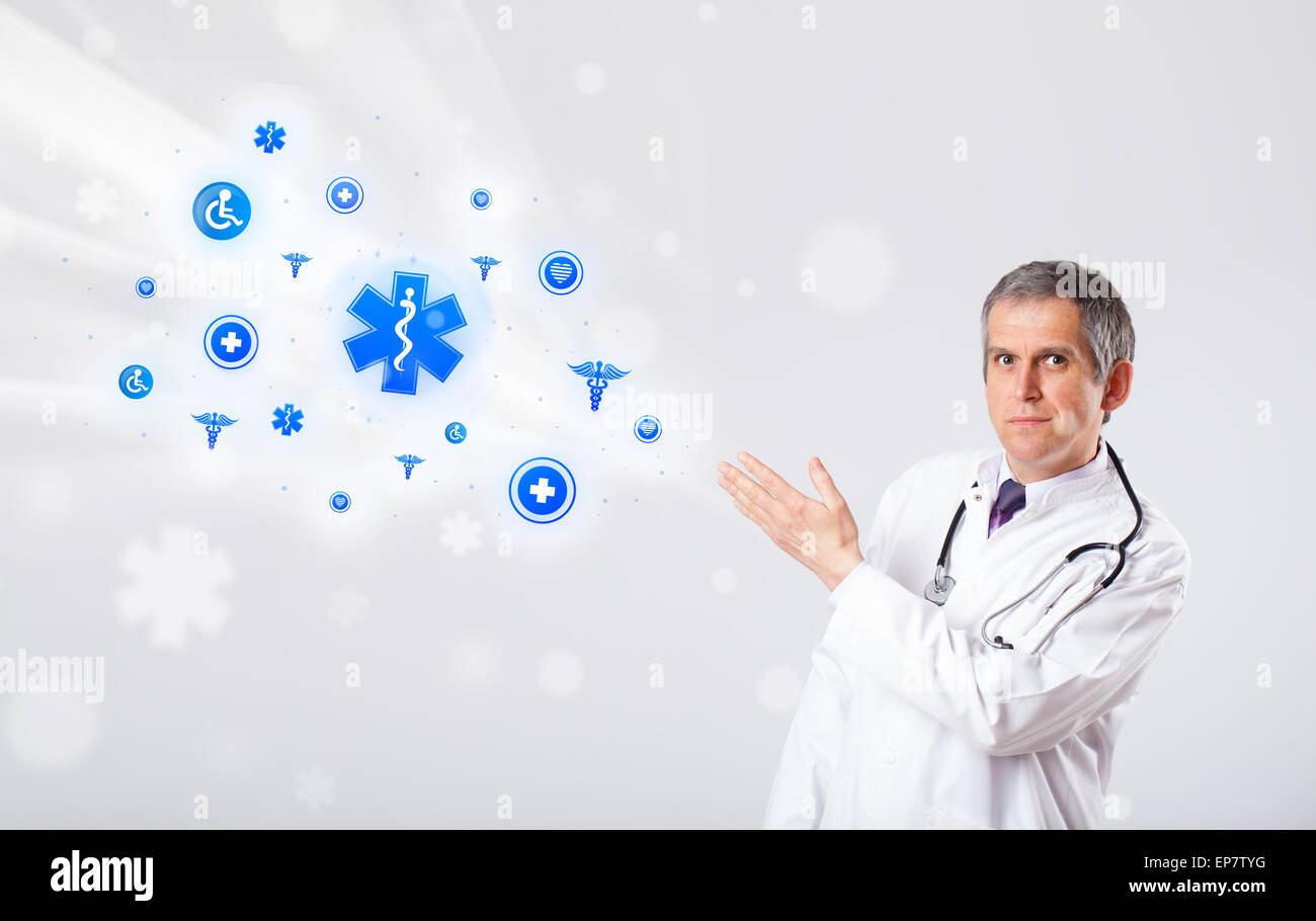 Doctor with blue medical icons Stock Photo - Alamy