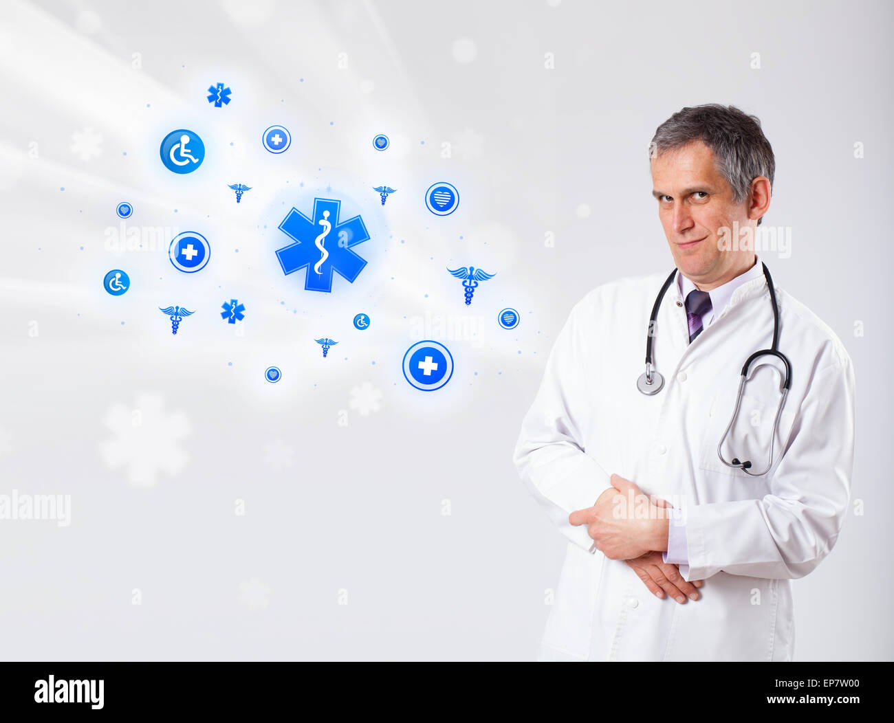 Doctor with blue medical icons Stock Photo - Alamy