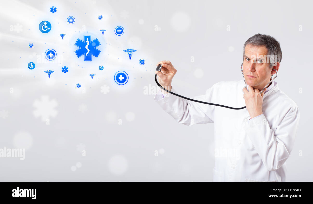 Doctor with blue medical icons Stock Photo - Alamy
