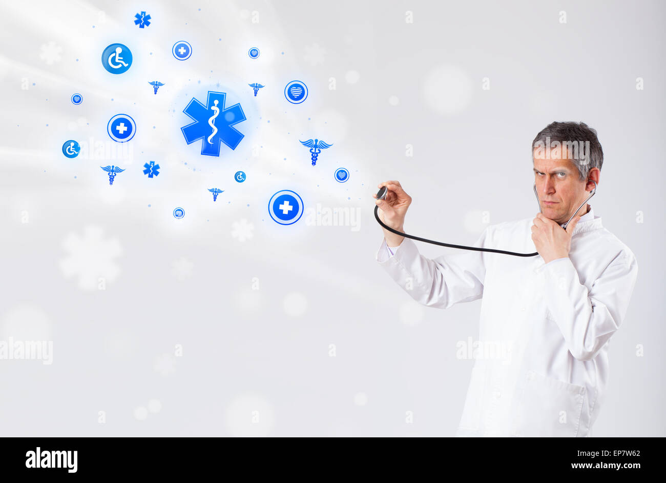 Doctor with blue medical icons Stock Photo - Alamy