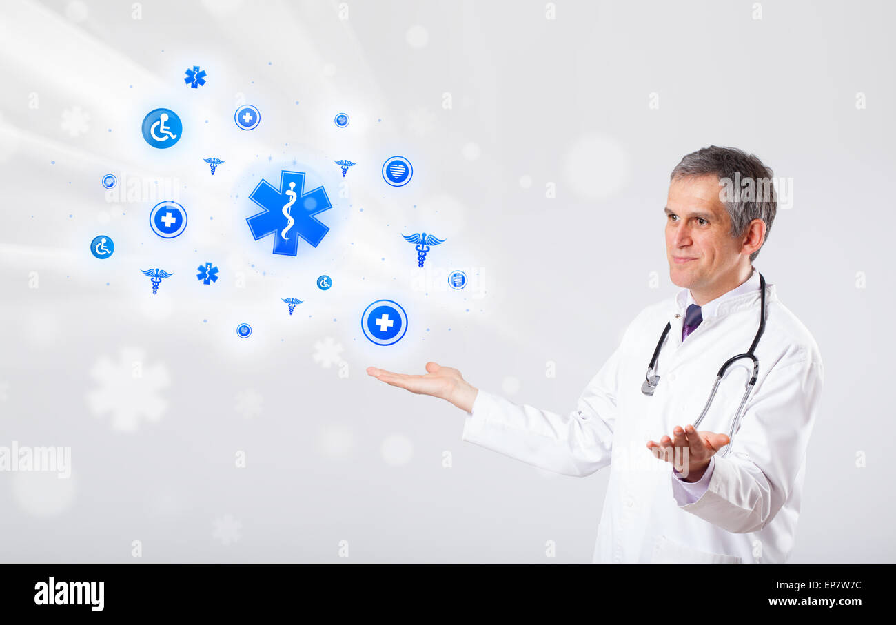 Doctor with blue medical icons Stock Photo - Alamy