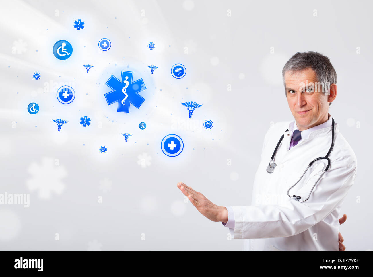 Doctor with blue medical icons Stock Photo - Alamy