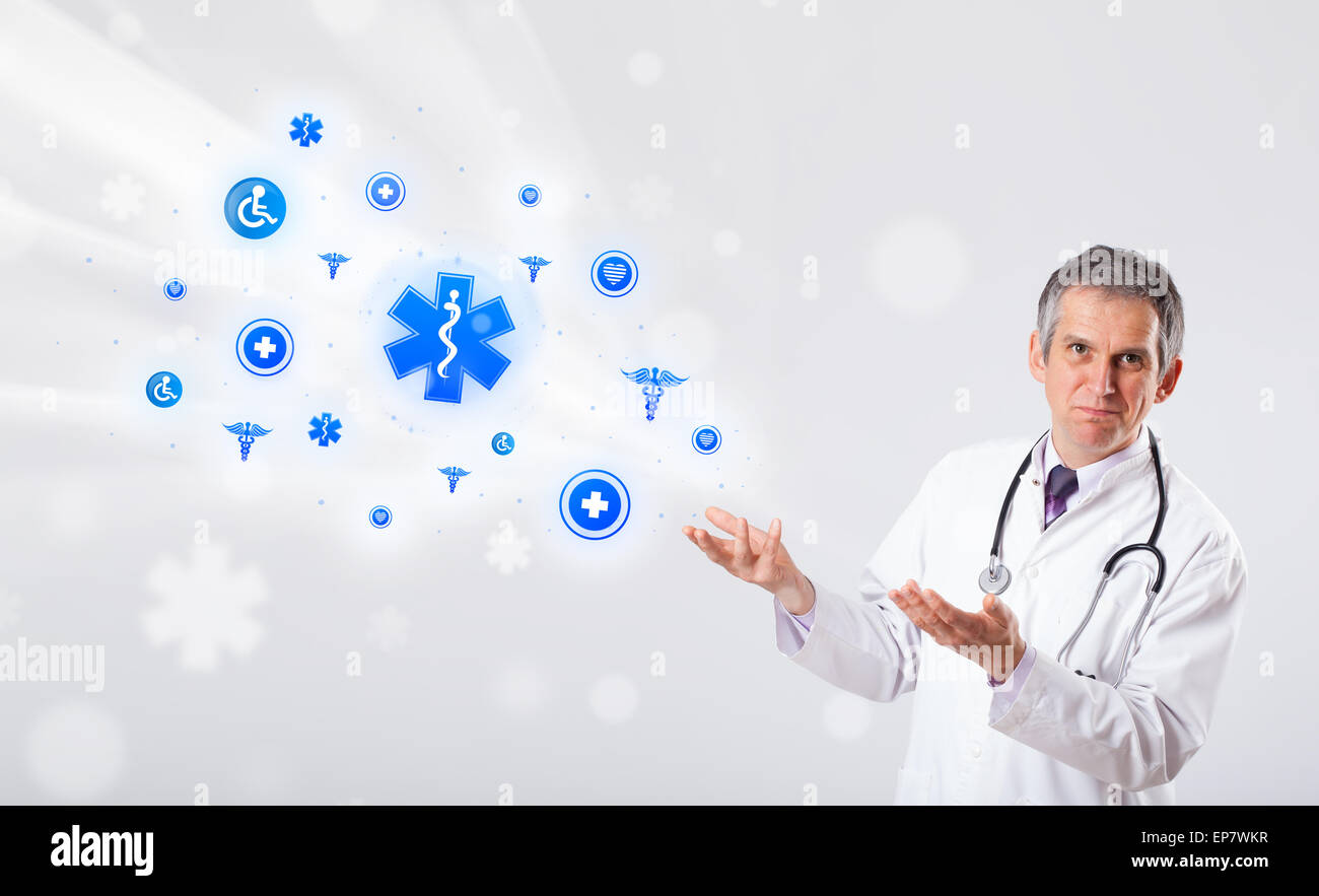 Doctor with blue medical icons Stock Photo - Alamy