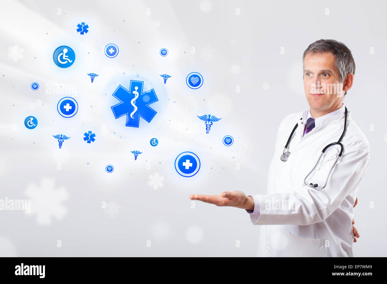 Doctor with blue medical icons Stock Photo - Alamy