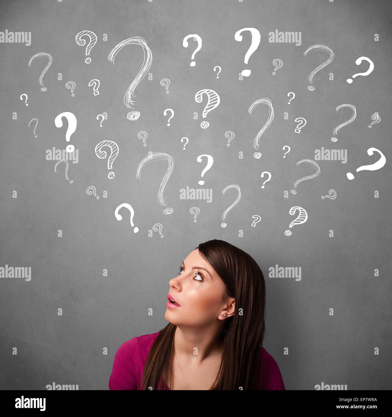 Young woman with question marks above her head Stock Photo - Alamy