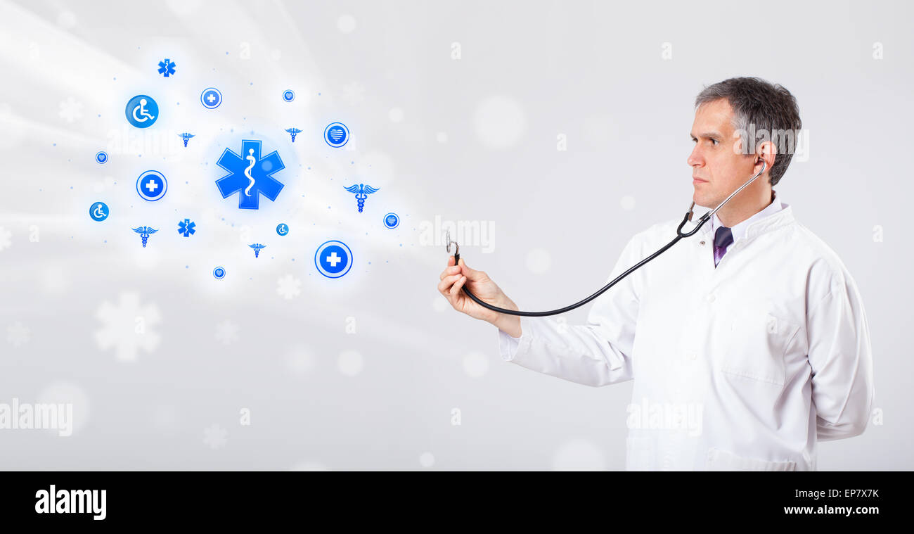 Doctor with blue medical icons Stock Photo - Alamy