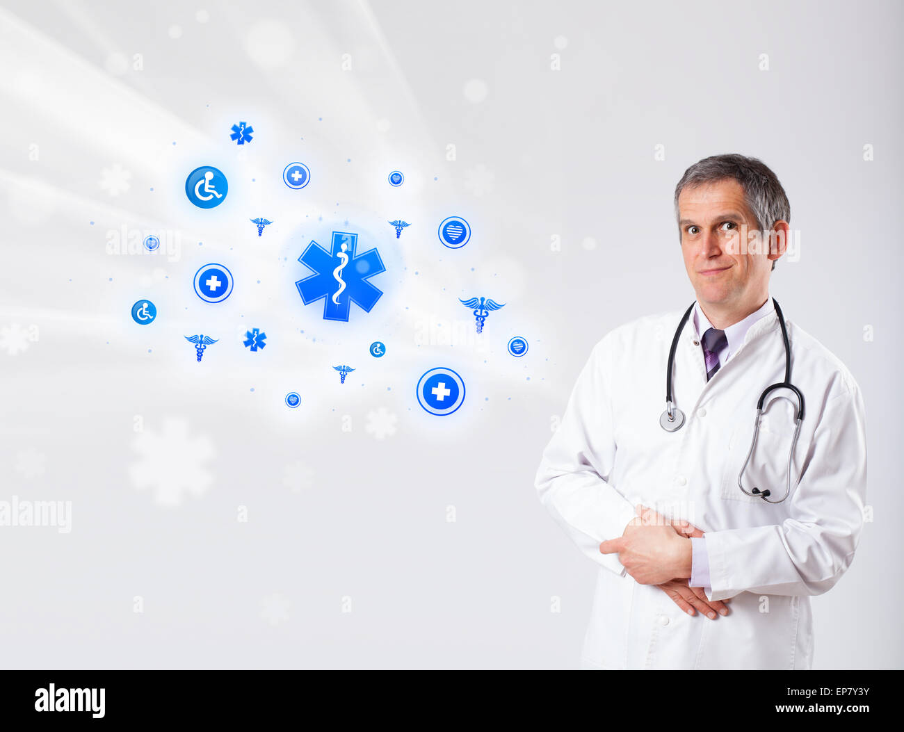 Doctor with blue medical icons Stock Photo - Alamy