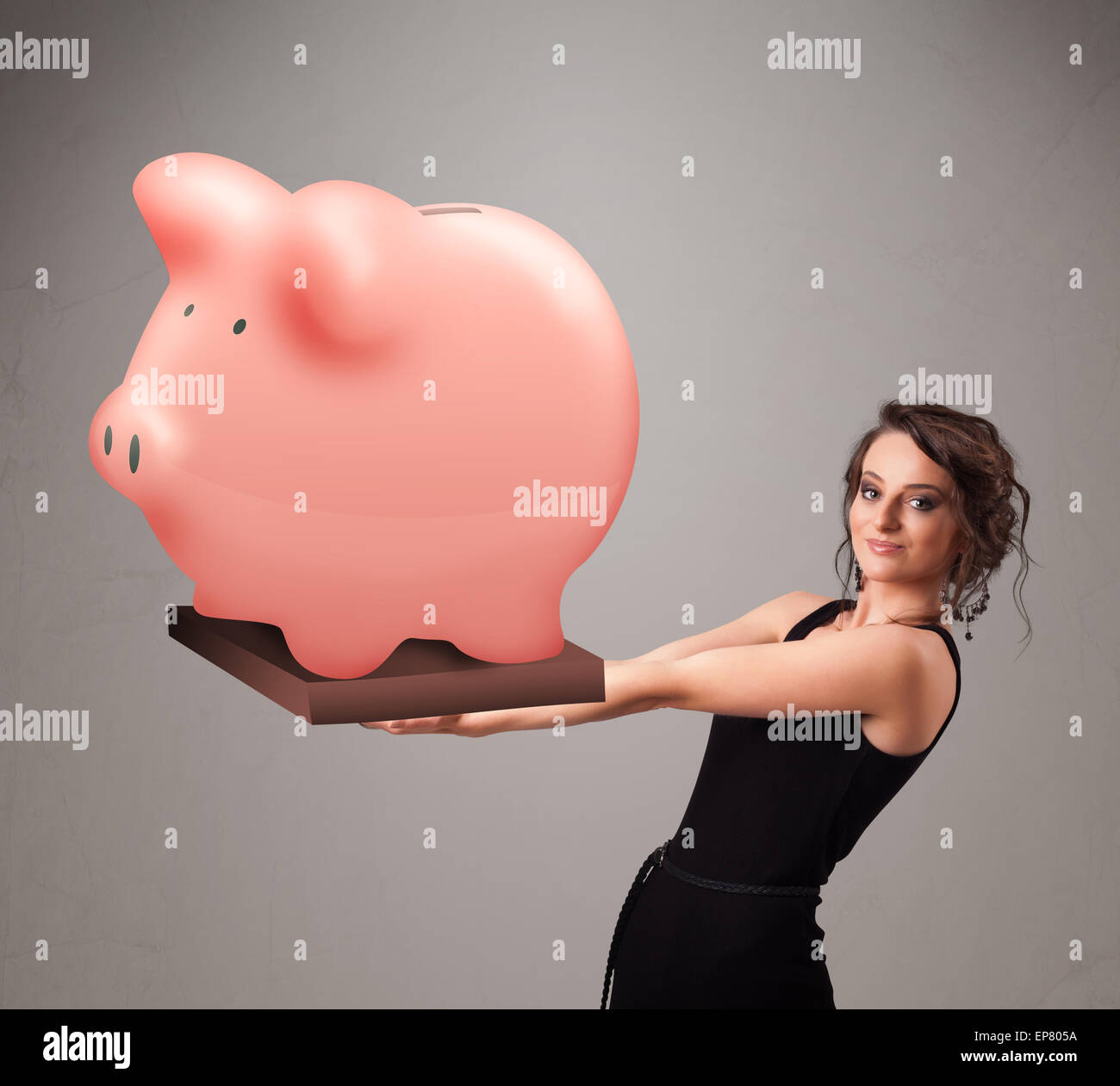 Young girl holding a huge savings piggy bank Stock Photo - Alamy