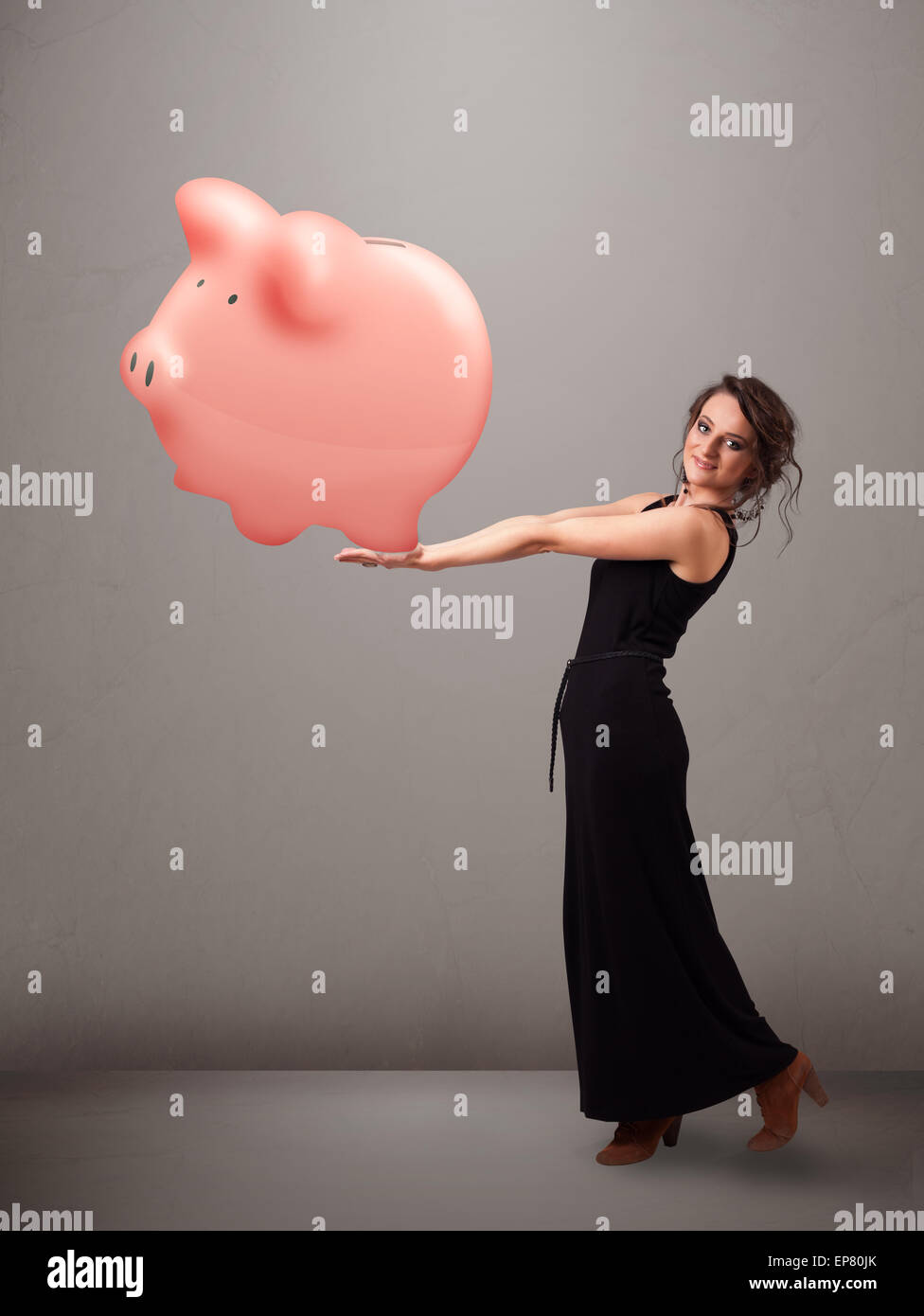 Young girl holding a huge savings piggy bank Stock Photo - Alamy