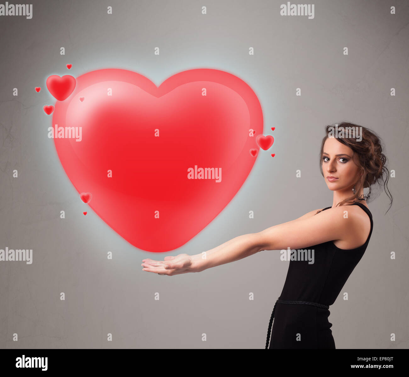 Young lady holding lovely 3d red heart Stock Photo - Alamy