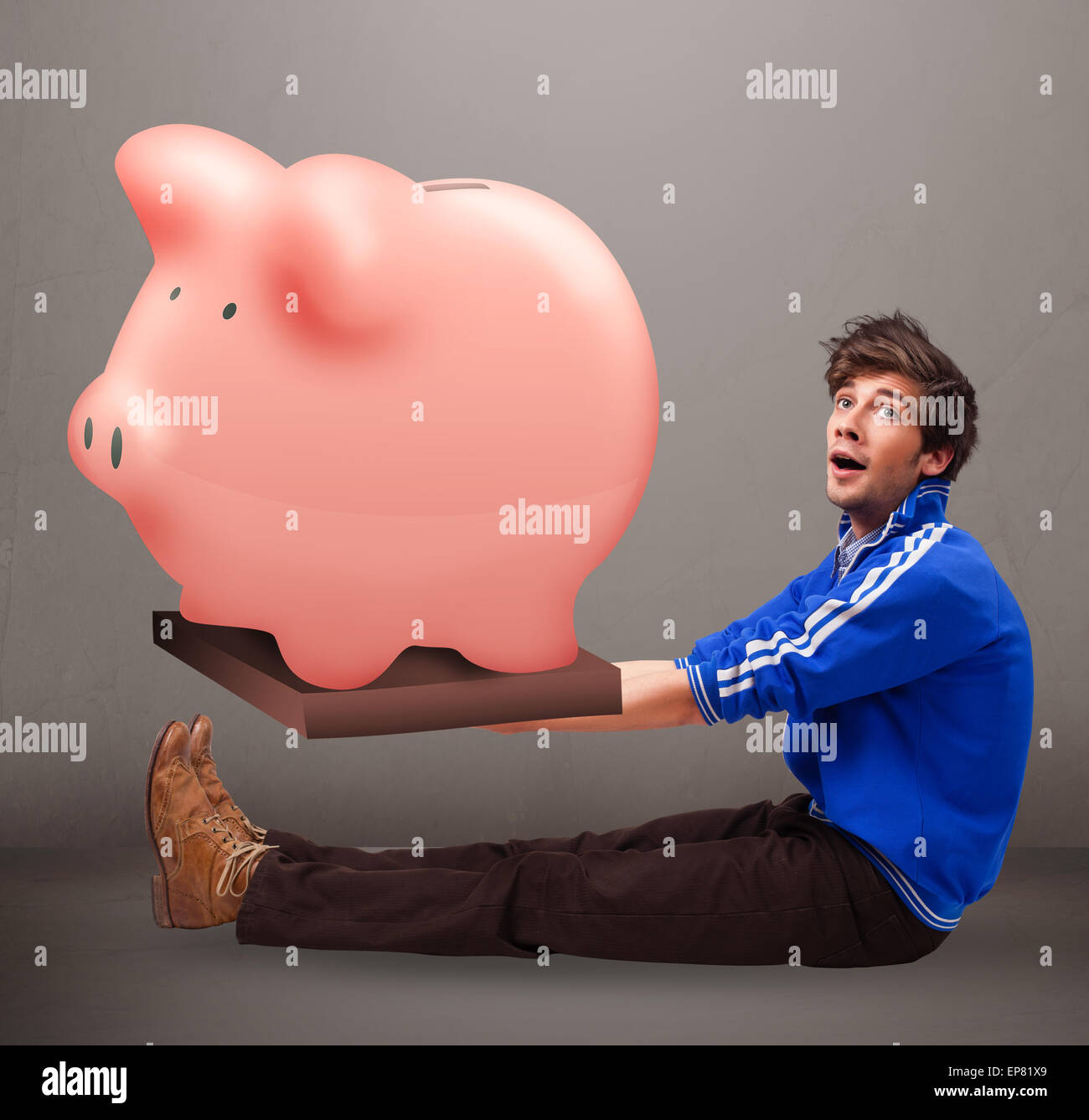 Handsome man holding a huge savings piggy bank Stock Photo - Alamy