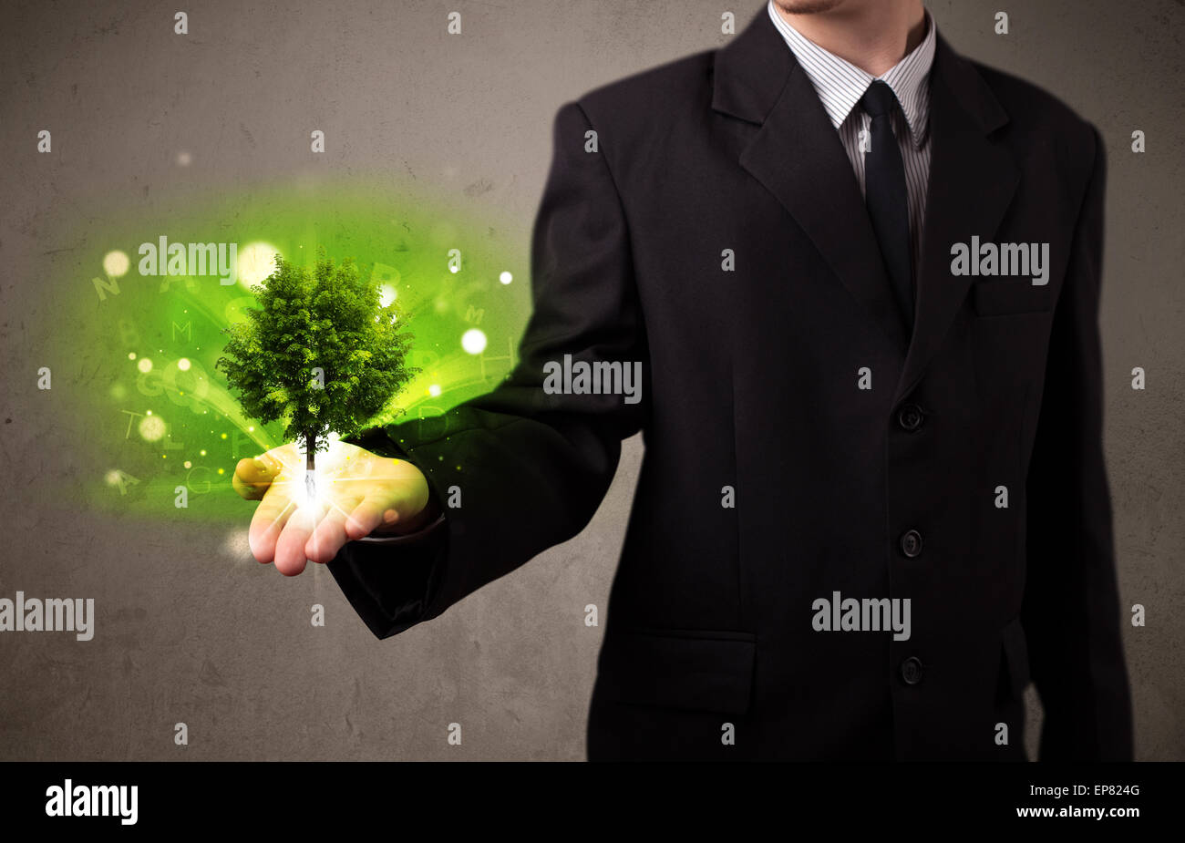 Glowing tree growing in the hand of a businessman Stock Photo - Alamy